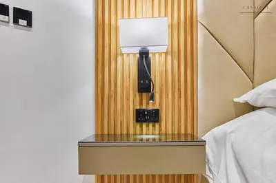 a lamp on a side table next to a bed at Water Front, State of the Art Furniture, Burj View sleeps 4 in Dubai