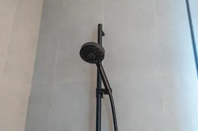 a shower head on a pole in a bathroom at Water Front, State of the Art Furniture, Burj View sleeps 4 in Dubai