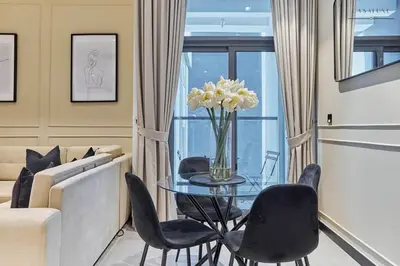a living room with a glass table and chairs at Water Front, State of the Art Furniture, Burj View sleeps 4 in Dubai