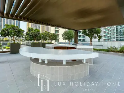 a lobby with two white tables in a building at LUX The Creek Palace Residence Suite 2 in Dubai