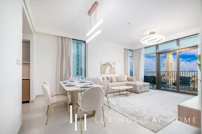 a white living room with a table and chairs at LUX The Creek Palace Residence Suite 2 in Dubai