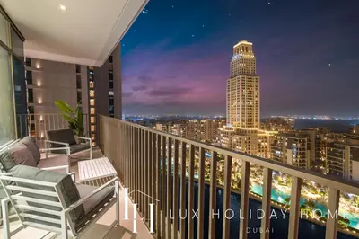 a balcony with a view of a city at night at LUX The Creek Palace Residence Suite 2 in Dubai