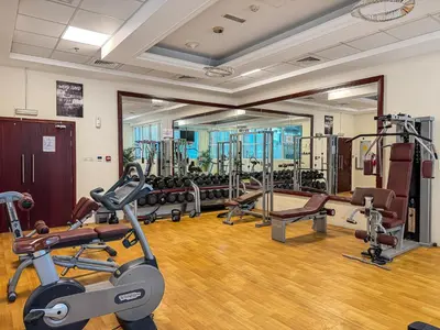 a gym with several treadmills and cardio machines at Bright 1BR with Canal Views Near Burj Khalifa in Dubai