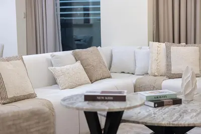 a living room with a white couch and a table at Charming 3BR Sea View 37th Floor in Dubai