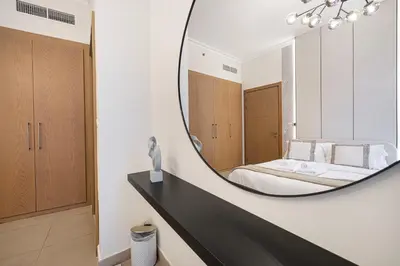 a bedroom with a large mirror on a counter at Charming 3BR Sea View 37th Floor in Dubai