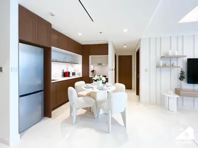 a kitchen and dining room with a white table and chairs at Beachfront 1B at Palm Jumeirah with Balcony & Views in Dubai