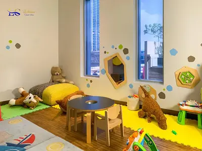 a childs bedroom with a table and teddy bears at Le Chateau Vacation Homes,Fashion Avenue Residence in Dubai