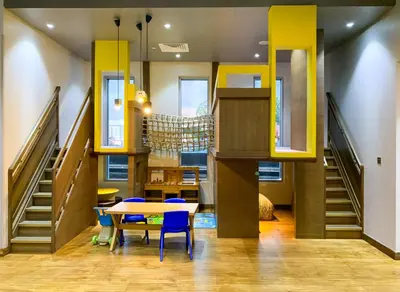 a dining room with a table and chairs and stairs at Le Chateau Vacation Homes,Fashion Avenue Residence in Dubai