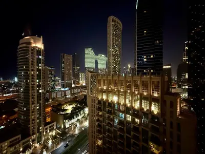 a view of a city at night with tall buildings at Urban Retreat 1BR with Pool & Burj Glimpse in Dubai