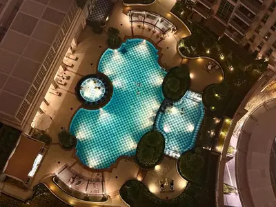 an overhead view of a swimming pool in a resort at Urban Retreat 1BR with Pool & Burj Glimpse in Dubai