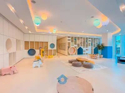 a large room with a library with tables and chairs at Next to Burj Khalifa & Dubai Mall Luxury 2BR Grande Signature - Like Home in Dubai