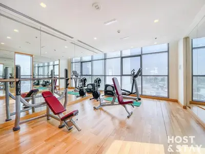 a gym with treadmills and exercise equipment in a building at Modern Studio in Loreto 1A, Damac Hills in Dubai