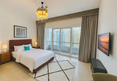 a bedroom with a bed and a large window at AquaVista Ensuite Room - Lakeview in Dubai