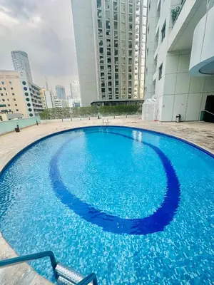 a large blue pool in the middle of a building at AquaVista Ensuite Room - Lakeview in Dubai