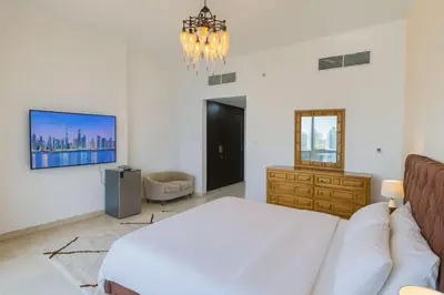 a bedroom with a bed and a tv on the wall at AquaVista Ensuite Room - Lakeview in Dubai