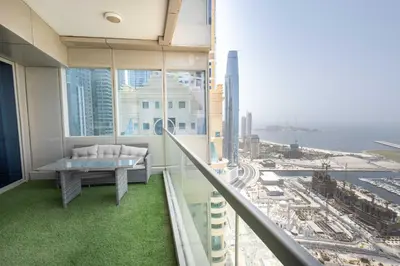 a balcony with a table and a view of a city at Luxuries Sky View Apartment in Dubai