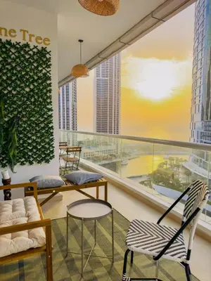 a living room with chairs and a large window at Walk to JBR Marina Beach & Tram! Luxury Family 3BD, Stunning Views in Dubai