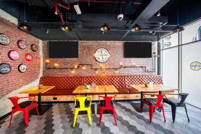 a restaurant with wooden tables and colorful chairs at Hilton Garden inn Dubai Jumeirah in Dubai