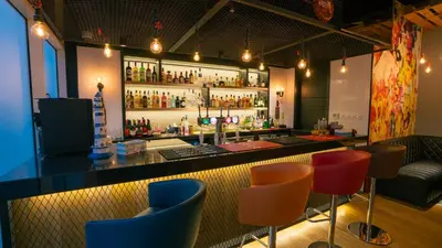 a bar with colorful bar stools in a restaurant at Hilton Garden inn Dubai Jumeirah in Dubai