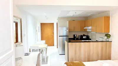 a kitchen with a refrigerator and a counter top at MARINA VIEWs STUDIO APARTMENT in Dubai