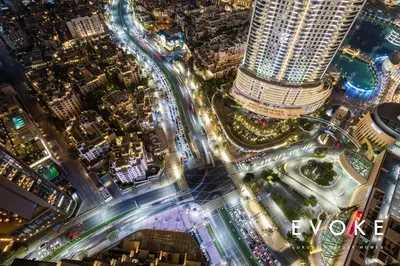 an overhead view of a city at night at Luxury 2BR by Evoke Burj & fountain View w Sofa bed & Balcony in Dubai