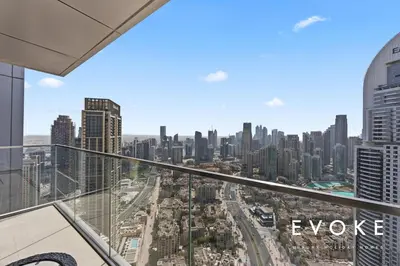 a view of the city from the balcony of a skyscraper at Luxury 2BR by Evoke Burj & fountain View w Sofa bed & Balcony in Dubai