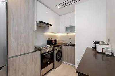 a kitchen with a stove and a dishwasher at Elegant 1BR Apartment Me Do Re Tower in JLT in Dubai