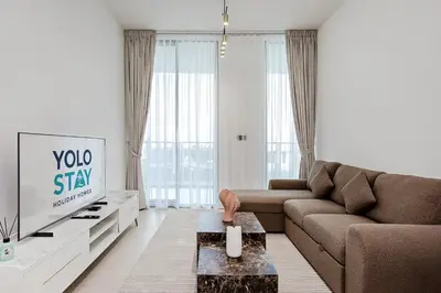 a living room with a couch and a tv at Inviting 1BR Apartment in JVC in Dubai