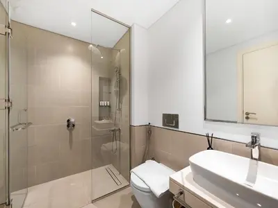 a bathroom with a shower and a toilet and a sink at Modern Jumeirah Apartment Near Beach in Dubai