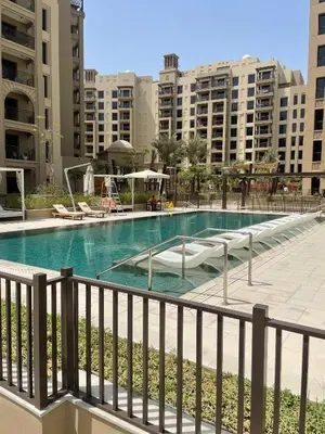 a swimming pool in the middle of some buildings at Modern Jumeirah Apartment Near Beach in Dubai