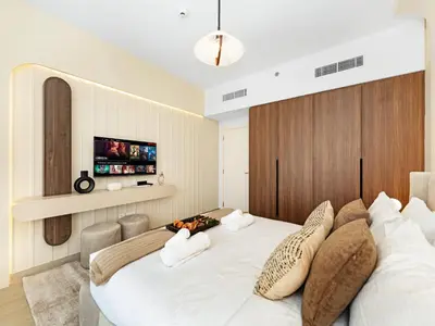 a bedroom with a large white bed with pillows at Modern Jumeirah Apartment Near Beach in Dubai