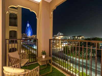 a balcony with a view of the city at night at Modern Jumeirah Apartment Near Beach in Dubai
