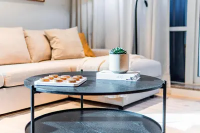 a coffee table in a living room with a couch at Luxury Lakeview Escape in Dubai