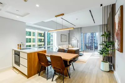 a kitchen and dining room with a table and chairs at Luxury Lakeview Escape in Dubai