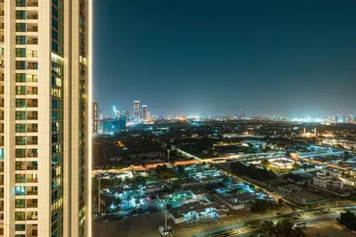 a view of a city at night from a skyscraper at Exquisite 2BR Apartment near Dubai Mall, Downtown Dubai in Dubai