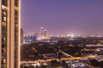 a city skyline at night with a tall building at Exquisite 2BR Apartment near Dubai Mall, Downtown Dubai in Dubai