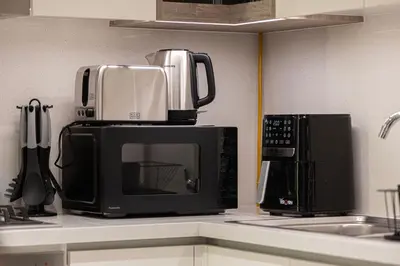 a microwave sitting on top of a kitchen counter at Exquisite 2BR Apartment near Dubai Mall, Downtown Dubai in Dubai