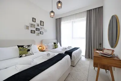 a hotel room with two beds and a mirror at Exquisite 2BR Apartment near Dubai Mall, Downtown Dubai in Dubai