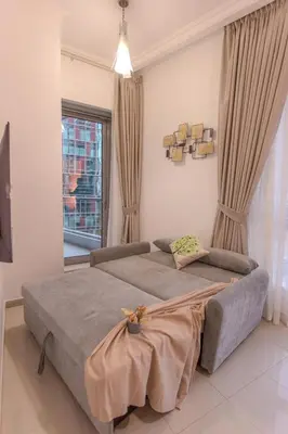 a bedroom with a large bed and a window at Stylish Studio Apartment with a Balcony Offering Sophistication, Spectacular Views & Beachside Living! in Dubai