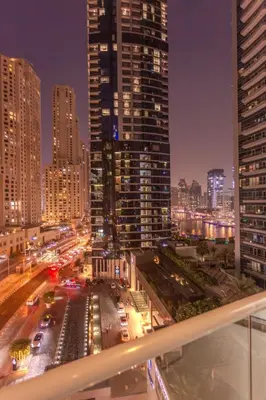 a view of a city at night with traffic at Stylish Studio Apartment with a Balcony Offering Sophistication, Spectacular Views & Beachside Living! in Dubai