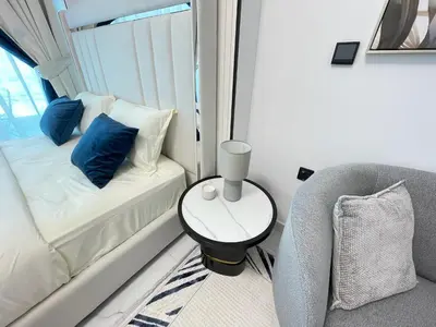 a room with a couch and a chair and a window at Cosy Studio in Opalz by Danube, Al Barsha South in Dubai