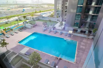 an overhead view of a swimming pool in a building at Cosy 1BR in Sobha Hartland in Dubai