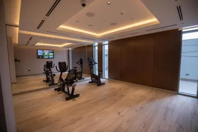 a gym with treadmills and ellipticals in a room at Cosy 1BR in Sobha Hartland in Dubai
