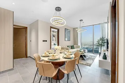 a dining room and living room with a table and chairs at Classy 2BR Dubai Getaway Near Downtown in Dubai