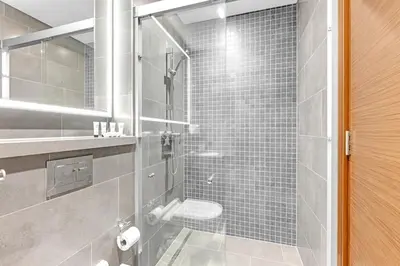 a bathroom with a glass shower with a toilet at Classy 2BR Dubai Getaway Near Downtown in Dubai
