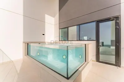 a large aquarium in a room with a large window at Minutes from Circle Mall, Grocery Stores & Bus Stop 2BR with Mini Private Pool on Balcony, Binghatti Tulip, Jumeirah Village Circle by Deluxe Holiday Homes in Dubai