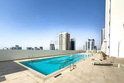 a swimming pool on the roof of a building at Minutes from Circle Mall, Grocery Stores & Bus Stop 2BR with Mini Private Pool on Balcony, Binghatti Tulip, Jumeirah Village Circle by Deluxe Holiday Homes in Dubai