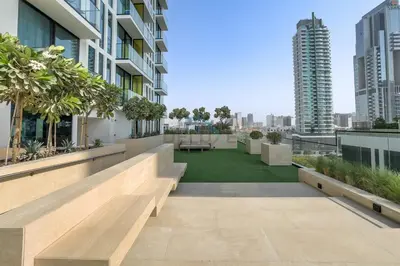 a view from the roof of a building with a lawn at Minutes from Circle Mall, Grocery Stores & Bus Stop 2BR with Mini Private Pool on Balcony, Binghatti Tulip, Jumeirah Village Circle by Deluxe Holiday Homes in Dubai