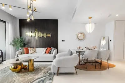 a living room with a couch and a table at Novity Signature Homes in Dubai