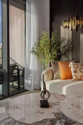 a living room with a couch and a glass table at Novity Signature Homes in Dubai